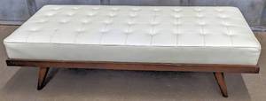 lot 8 image: Extra Large Ecru Faux Leather Upholstered Bench  Platform Ottoman on Wood Base with Tapered Legs