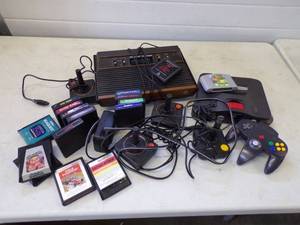 lot 47 image: Vintage Atari Nintendo Game Councils and Accessories With a variety of Games Untested