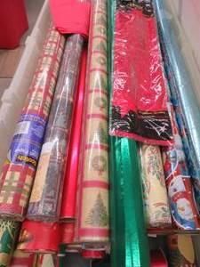 TOTE FULL OF CHRISTMAS WRAPPING PAPER.
