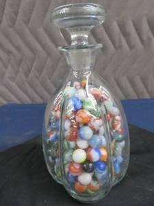 lot 23 image: VINTAGE MARBLES IN A VINTAGE BOTTLE