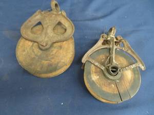 lot 41 image: LARGE  SMALL CAST IRON AND WOOD PULLYS