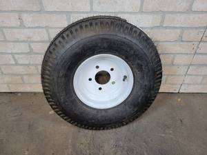 lot 818 image: New 6.906.00 - 9 Tire and Rim - 5 on 4-12 Rim