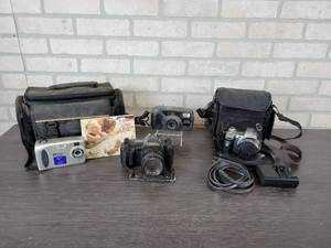 lot 1169 image: Lot of Cameras - 35mm Canon T70, 35mm Pentax ZOOM90-WR, Digital HP Photosmart hp215, Digital Sony Cyber Shot Super SteadyShot, and Various Cases