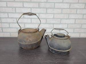 lot 1192 image: Pair of Cast Iron CoffeeTea Pots