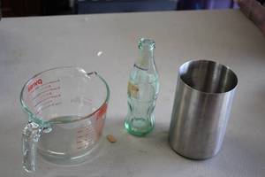 lot 900 image: Measuring Cup, Utensil Holder, Coca-Cola Bottle Celebrating 100 Years of Olympics (empty)