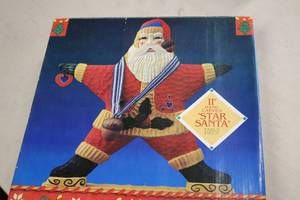 lot 574 image: 11 Hand Carved Star Santa Table Piece (in original packaging)