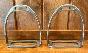 lot 137 image: Stirrups and a Horseshoe Frame by Twos Company