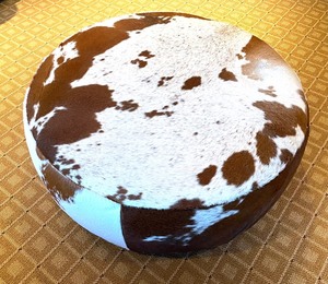 lot 15A image: Cowhide Round Lind Ottoman on Casters from Room and Board