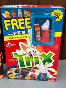 lot 383A image: 2002 Coca Puffs Cereal with Collectible Cuck Coo Bird Pez Dispenser & Vintage Trix Cereal Box with Pez Dispenser