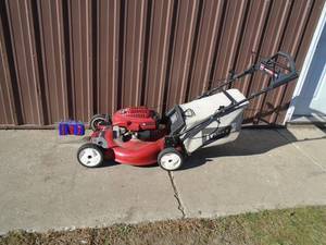 lot 107 image: Toro mower was personal pace with bagger. Now a push mower. Tested & works. As shown.