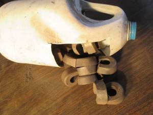 lot 164 image: Bottle full of horseshoe shapes mag...