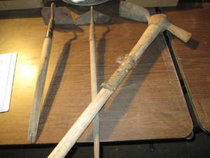 lot 219 image: 2 hoes and a pik axe...
