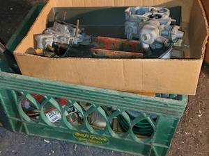 lot 456 image: Box with carburetor parts and a mil...