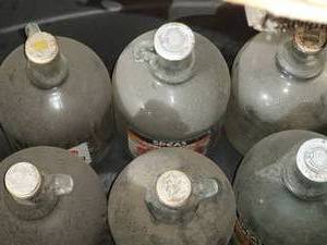lot 508 image: Tote w 6 glass 1 gal jugs and caps...