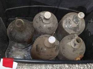 lot 509 image: Tote w 5 glass 1 gal jugs, 3 have ...
