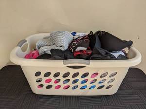 Various Sized Childrens Clothes and Clothes Basket