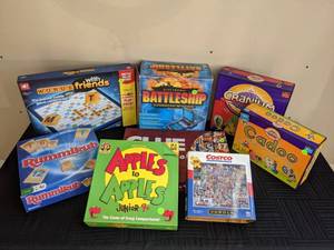 A Collection of Board Games Including Cadoo, Cranium, Battleship, Words with Friends, Clue, Rummikub, Costco Puzzle, Apples to Apples