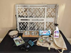 A Variety of Dog Items Including MyPet Gate, Car Hammock, Food Bowls, Dog Training Bowl, Pet Brush, Disposable Diapers and Potty-Training Spray