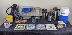 lot 59 image: Mixed Lot of Kitchen Wares Insulated Coffee Carafes, PUR Water Pitcher, Coleman PolyLite Water Jug, Insulated Travel Mugs, Ceramic Coffee Cups, and More