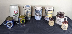 lot 61 image: (2) Billy Bayou Tin Mugs, Spaten Beer Mug, (3) Ceramic Latch Canisters, McCormick Corn Whiskey Jug, Ceramic Crocks