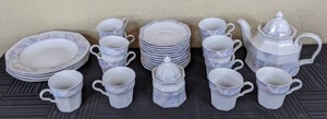 lot 52 image: Pastel Southwest Patterned Dishware Set with Plates, Saucers, Cups, Sugar Bowl, and Tea Pot with Lid