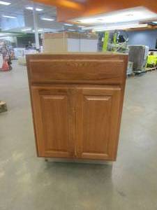 lot 259 image: Hampton Bay Hampton Assembled 24 x 34.5 x 21 in. Bathroom Vanity Base Cabinet in Medium Oak (BOTTOM SIDES CRACKED, CHUNKS MISSING ON BOTTOM)
