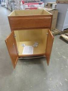 lot 260 image: Hampton Bay Hampton Assembled 24 x 34.5 x 21 in. Bathroom Vanity Base Cabinet in Medium Oak (BOTTOM SIDES CRACKED)