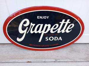 lot 64 image: Vintage Reproduction Grapette Soda Oval Sign