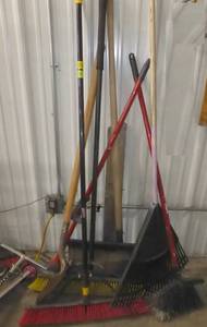 lot 4 image: group of brooms, rake, shovel