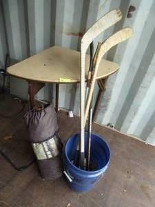 lot 99 image: Bucket of about a dozen baseballs, 4 hockey sticks and a tent