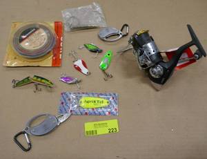 lot 223 image: Fishing lures, trolling line and spinning reel like new, removed from a rodreel set where the rod tip was broke