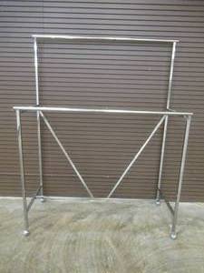 lot 56 image: Econoco LNH60 Linea Double Bar Apparel Rack with V-brace On Casters.