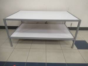 lot 140 image: 2-Tier Display Table. Approximate Dimensions 48 x 30 x 22 12 Tall. Slight Scratch and Dent.