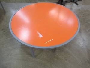 lot 156 image: Round Display Table, Orange Top, Approximate Dimensions 44 Dia x 15 12 Tall. Scratch and Dent.
