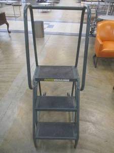 lot 247 image: Metal Step Ladder With Hand Rails, Casters for easy transport. Approximate Dimensions 19 x 32 x 54 Tall.