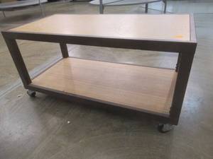 lot 285 image: Rolling Wooden 2-Tier Table With Steel Frame, Approximate Dimensions 48 x 24 x 24 Tall. Slight Scratch and Dent.
