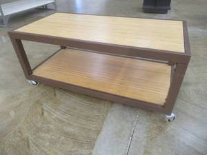 lot 288 image: Rolling Wooden 2-Tier Table With Steel Frame, Approximate Dimensions 48 x 24 x 21 Tall. Slight Scratch and Dent.
