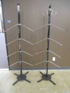 lot 331 image: (2) 16 Arm Metal Handbag Display Racks, New, Assembly Required. Assembled Dimensions 27 x 27 x 74 Tall. In Nice Condition.