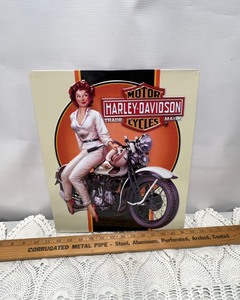 lot 366 image: Tin Sign- Harley Davidson Brunette on Bike