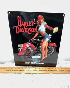 lot 371 image: Tin Sign- Harley Davidson Blonde Washing Bike