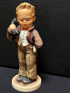 lot 201 image: Collection of Three Hummel Figurines - Hummel Figurine The Postman, Hummel Figurine Hello and Hummel Figurine The Photographer