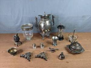 lot 260 image: A Collection of Silver Colored Items, Butter Dish, Salt and Pepper Teapot Shakers, Miniature Pot Belly Stove, Coffee Urn, Arizona Bird Figurine, Nautical Theme Decanter and More  M