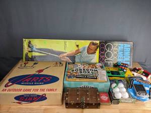 lot 723 image: Assortment of Games Arnold Palmers Indoor Golf Course, Outdoor Jarts Missile Game, The Boredom Box Games & Puzzles Edition, Digital Sudoku, Plastic Pick-Up Sticks, Cultist & Cthulhu, Who Am I, Dominos and More M