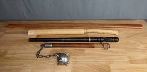 lot 718 image: Two Wooden Swords, Black Handled Sword with Sheath and Medieval Single Ball Flail  M