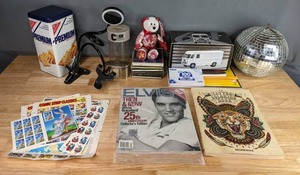 lot 743 image: Tattoo Coloring Book, Elvis Collectors Edition 25th Anniversary Then & Now Magazine, Elvis The Official Catalog, Comic Strip Classics, Premium Saltine Crackers Tin Box, Disco Ball, CDs, College Ruled Note Books and More M