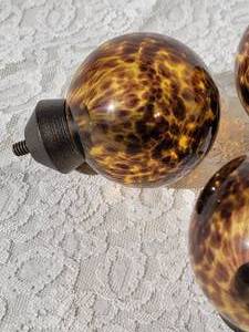 lot 124 image: Glass Tortoise Shell Rod Finials, set of 4