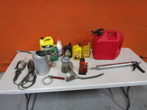 lot 77 image: Gas Jug, Suction Gun, Hydraulic Jack, Oil Cans, Funnel, Trouble Light