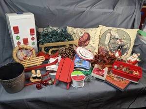 A Collection of Christmas Items Including Christmas Lights, Throw Pillows, Wooden Decorations, Decorative Towels, Ribbon and More