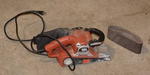 lot 176 image: BLACKDECKER BELT SANDER WITH EXTRA SANDING SHEETS