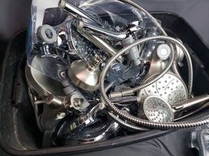 Tote Full of Various MOEN Magnetix Shower Heads and Parts